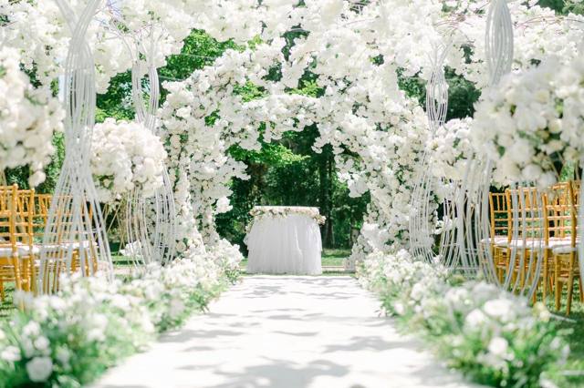 White floral ceremony arch and walkway