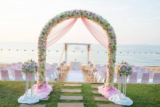 Beachfront ceremony arch at sunset