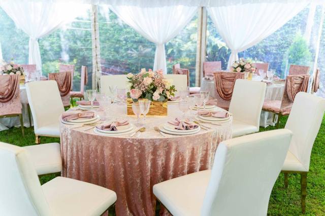 Draped marquee interior with round table settings