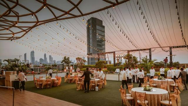 Evening service at a rooftop marquee reception